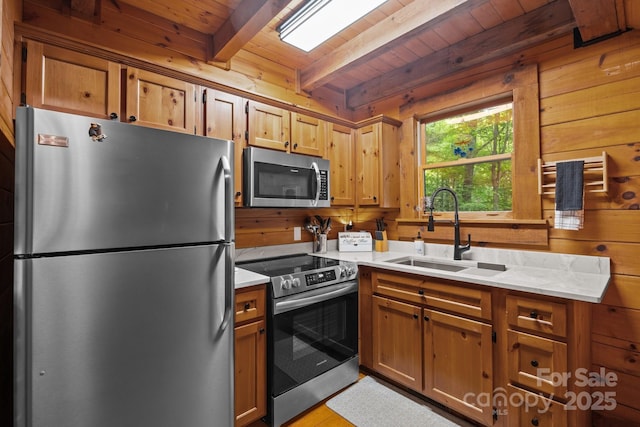 83 Log Cabin Dr, Maggie Valley, NC 28751 - kitchen featuring stainless steel appliances, a wood ceiling with exposed beams, light countertops, wooden walls, and brown cabinets