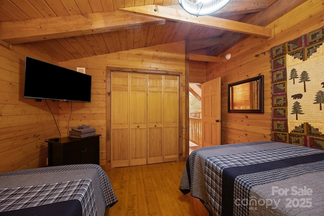 83 Log Cabin Dr, Maggie Valley, NC 28751 - bedroom featuring wood walls, light wood-type flooring, wooden ceiling, and a closet