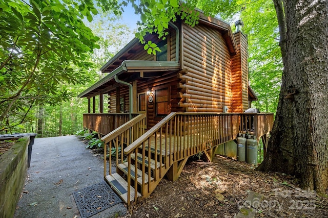 83 Log Cabin Dr, Maggie Valley, NC 28751 - view of front of property featuring log exterior, a chimney, and a deck