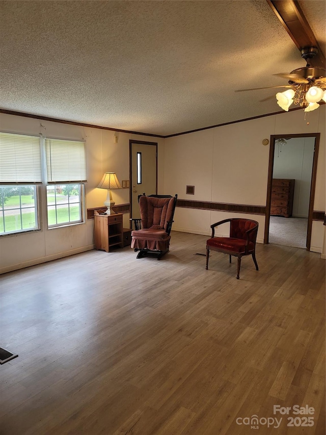 111 Crystal Creek Dr, China Grove, NC 28023 - living area with a textured ceiling, wood finished floors, a ceiling fan, and beam ceiling