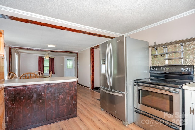 439 Neisler Rd, Concord, NC 28025 - kitchen with stainless steel appliances, crown molding, light wood-style flooring, a ceiling fan, and a textured ceiling