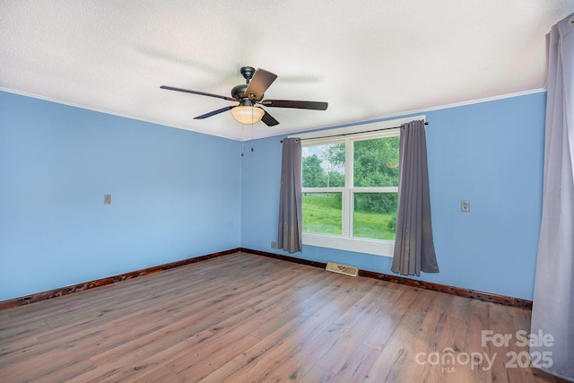 439 Neisler Rd, Concord, NC 28025 - spare room with wood finished floors, ceiling fan, a textured ceiling, and ornamental molding