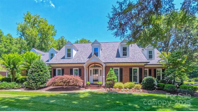 1240 Fawn Ridge Rd NW, Concord, NC 28027 - view of front facade featuring brick siding, a front yard, and a shingled roof