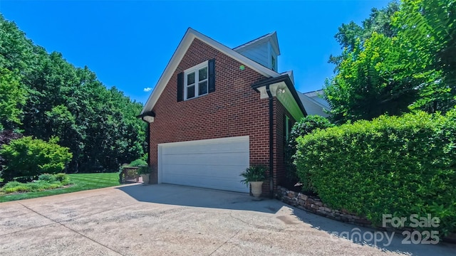 1240 Fawn Ridge Rd NW, Concord, NC 28027 - view of home's exterior with brick siding, an attached garage, and driveway