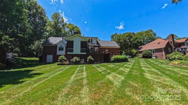 1240 Fawn Ridge Rd NW, Concord, NC 28027 - rear view of house with a yard, a wooden deck, and brick siding