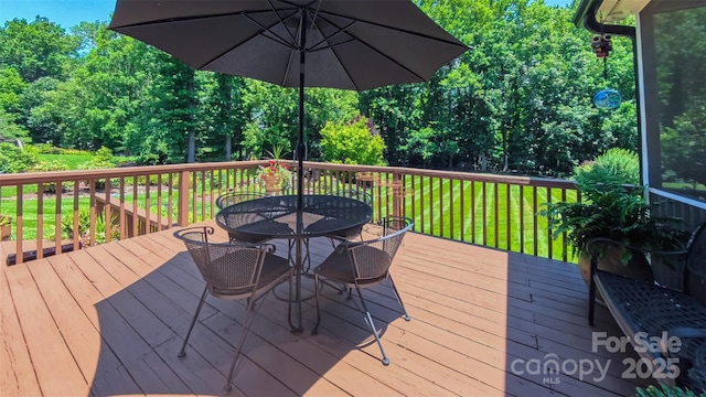 1240 Fawn Ridge Rd NW, Concord, NC 28027 - wooden deck featuring outdoor dining area and a lawn