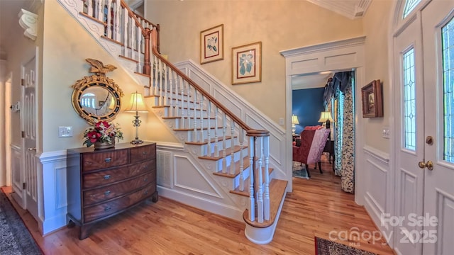 1240 Fawn Ridge Rd NW, Concord, NC 28027 - foyer featuring wood finished floors, ornamental molding, stairway, a decorative wall, and a towering ceiling