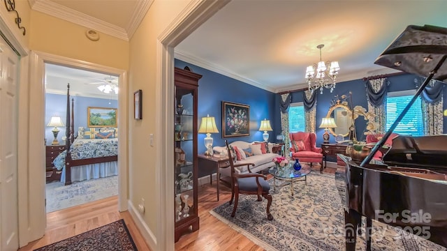 1240 Fawn Ridge Rd NW, Concord, NC 28027 - living area featuring wood finished floors, crown molding, a chandelier, and ceiling fan