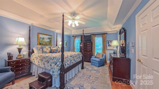 1240 Fawn Ridge Rd NW, Concord, NC 28027 - bedroom featuring a tray ceiling, ornamental molding, wood finished floors, and ceiling fan