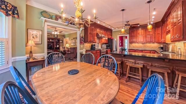 1240 Fawn Ridge Rd NW, Concord, NC 28027 - dining room featuring a ceiling fan, crown molding, and light wood-style flooring