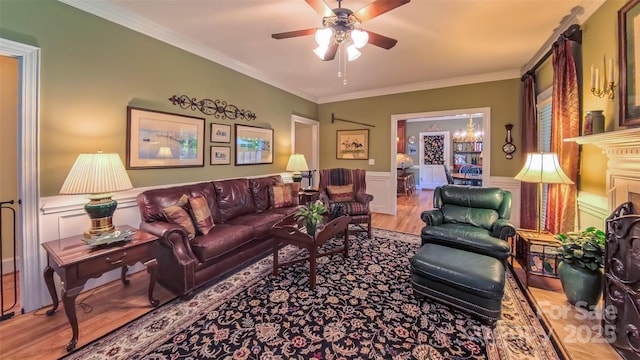 1240 Fawn Ridge Rd NW, Concord, NC 28027 - living area featuring wood finished floors, ornamental molding, ceiling fan, and a wainscoted wall