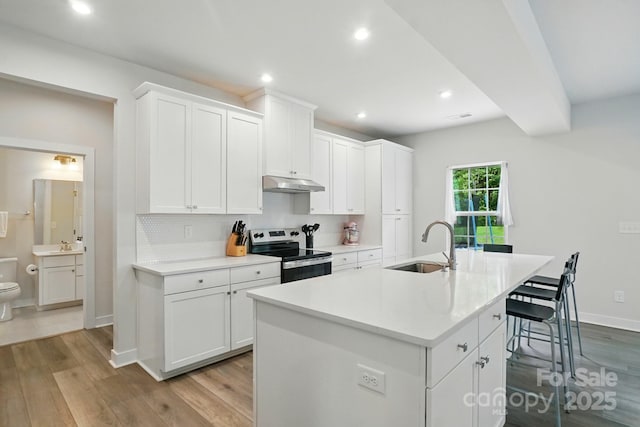 812 Dogwood Creek Ln, Indian Trail, NC 28079 - kitchen featuring electric range, under cabinet range hood, wood finished floors, white cabinetry, and recessed lighting
