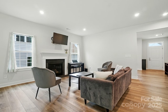 812 Dogwood Creek Ln, Indian Trail, NC 28079 - living area featuring light wood-style floors, a fireplace with flush hearth, and recessed lighting