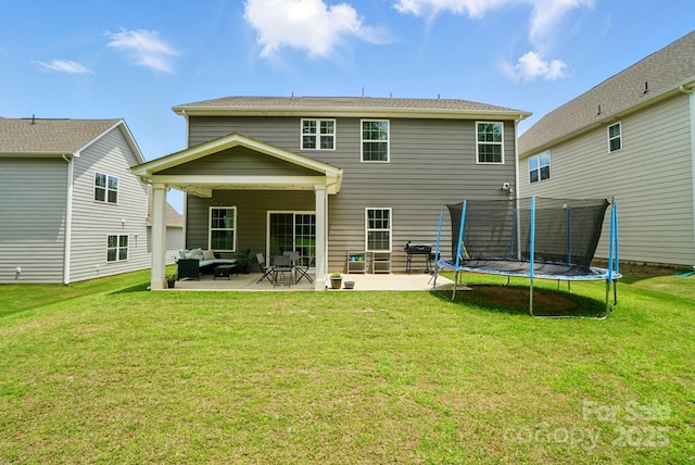812 Dogwood Creek Ln, Indian Trail, NC 28079 - back of house with a trampoline, a patio, and a yard