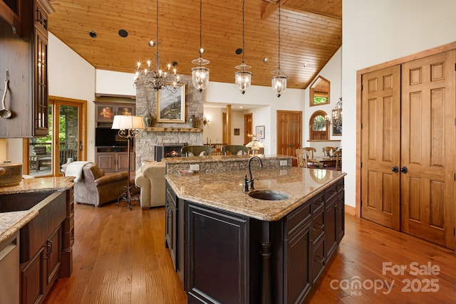 197 Cherry Knob Dr Unit 23, Mars Hill, NC 28754 - kitchen featuring open floor plan, wood ceiling, high vaulted ceiling, a stone fireplace, and a chandelier