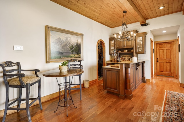 197 Cherry Knob Dr Unit 23, Mars Hill, NC 28754 - kitchen with a kitchen breakfast bar, glass insert cabinets, a wood ceiling with exposed beams, a peninsula, and light countertops