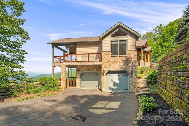 197 Cherry Knob Dr Unit 23, Mars Hill, NC 28754 - view of front of property with stone siding, a garage, asphalt driveway, and a balcony