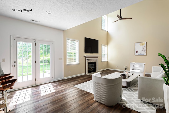 89 Woodfern Rd, Fletcher, NC 28732 - living room featuring wood finished floors, a fireplace with flush hearth, a textured ceiling, ceiling fan, and high vaulted ceiling