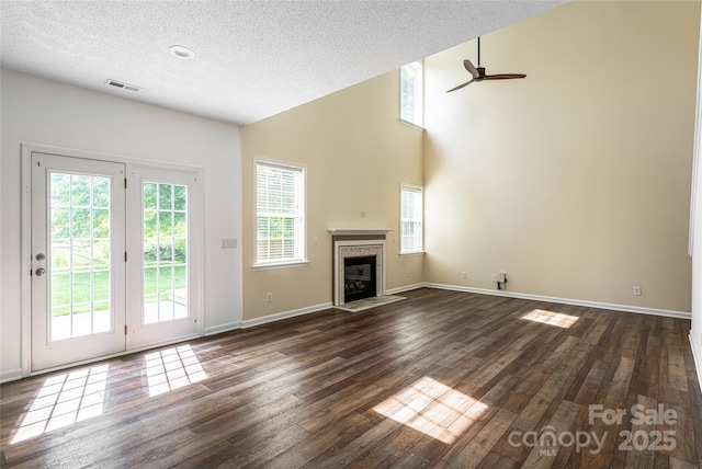 89 Woodfern Rd, Fletcher, NC 28732 - unfurnished living room with a ceiling fan, dark wood-style floors, a glass covered fireplace, a textured ceiling, and high vaulted ceiling