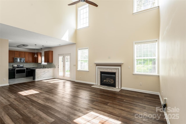 89 Woodfern Rd, Fletcher, NC 28732 - unfurnished living room featuring a high ceiling, dark wood-type flooring, a ceiling fan, and plenty of natural light