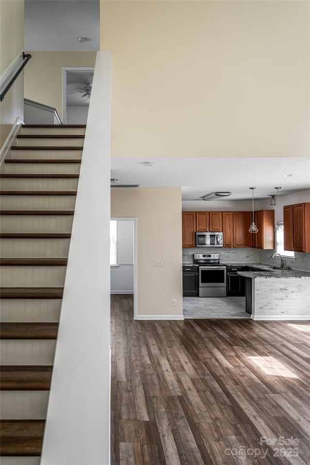 89 Woodfern Rd, Fletcher, NC 28732 - kitchen featuring stainless steel appliances, dark wood finished floors, brown cabinetry, and pendant lighting