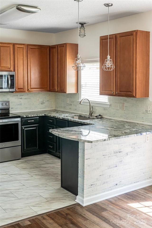 89 Woodfern Rd, Fletcher, NC 28732 - kitchen featuring stainless steel appliances, light stone counters, backsplash, and brown cabinetry