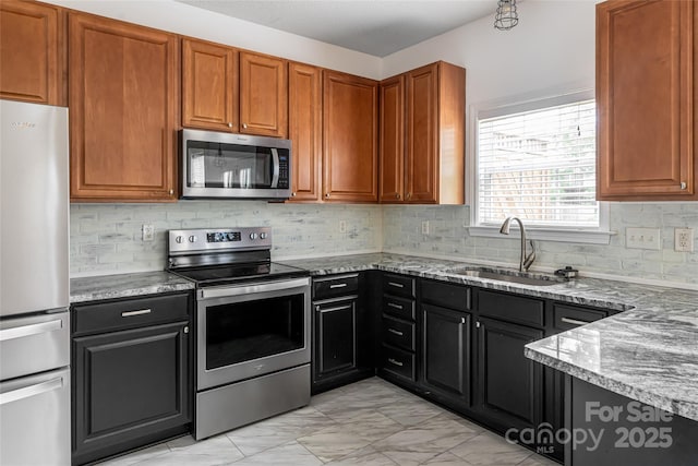 89 Woodfern Rd, Fletcher, NC 28732 - kitchen featuring stainless steel appliances, light stone countertops, light marble finish flooring, decorative backsplash, and brown cabinets