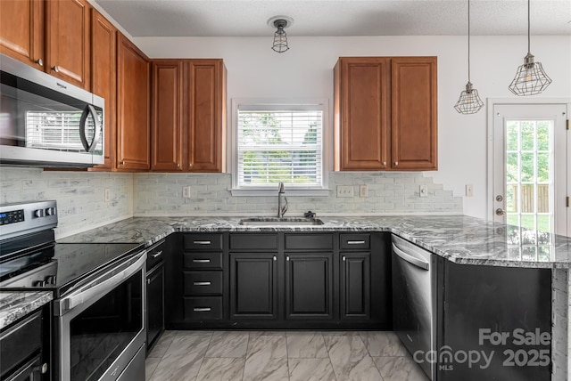 89 Woodfern Rd, Fletcher, NC 28732 - kitchen featuring appliances with stainless steel finishes, a peninsula, stone countertops, light marble finish floors, and decorative backsplash