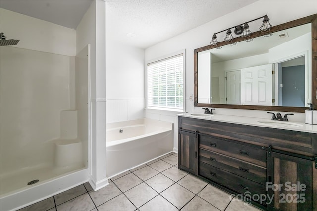 89 Woodfern Rd, Fletcher, NC 28732 - bathroom featuring double vanity, tile patterned floors, a bath, a textured ceiling, and a wainscoted wall
