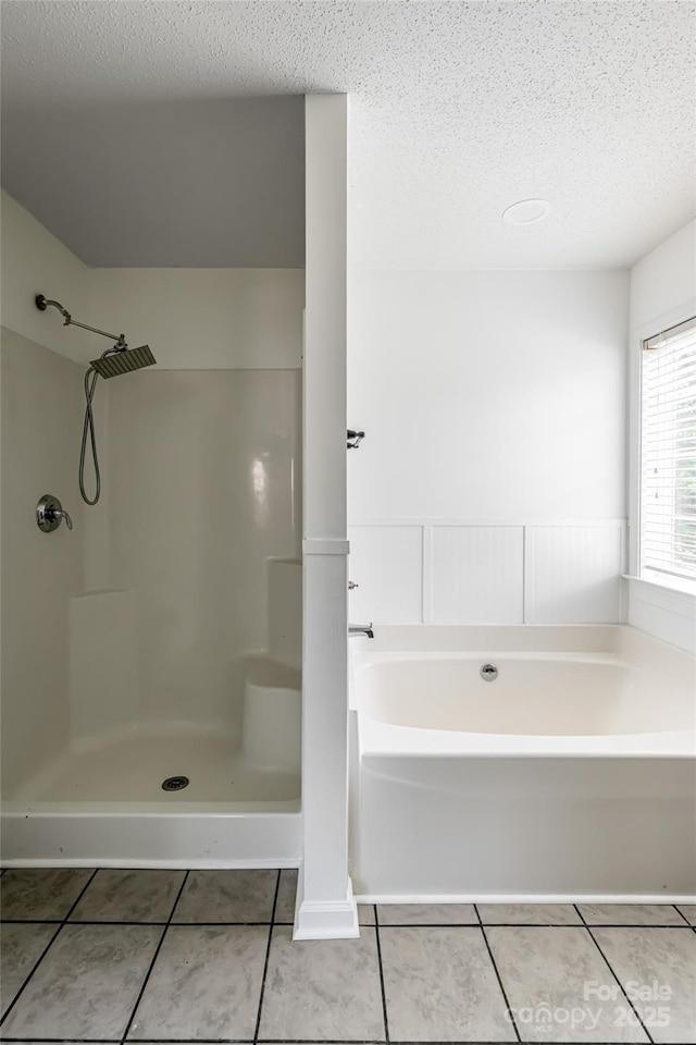 89 Woodfern Rd, Fletcher, NC 28732 - bathroom with tile patterned floors, a garden tub, a textured ceiling, and a walk in shower