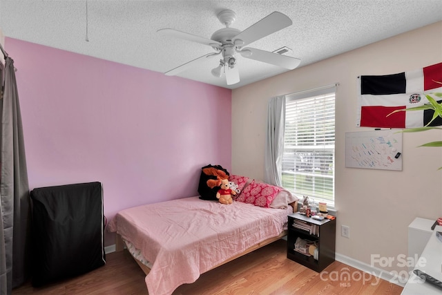 15248 Pangborn Pl, Charlotte, NC 28278 - bedroom featuring wood finished floors, a textured ceiling, and a ceiling fan