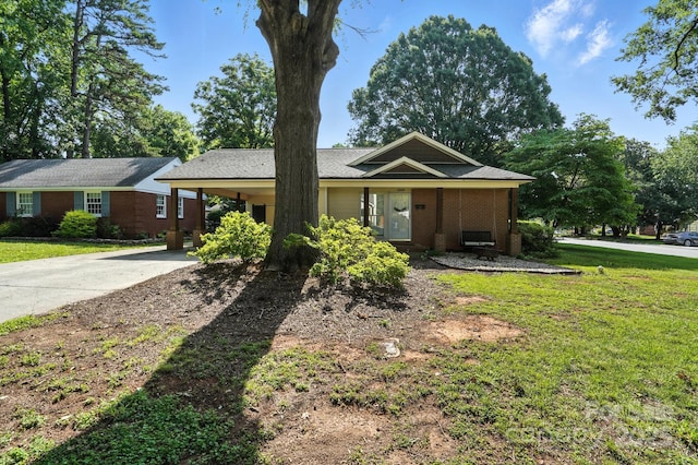 5229 Milford Rd, Charlotte, NC 28210 - ranch-style house featuring driveway, a front yard, an attached carport, and brick siding