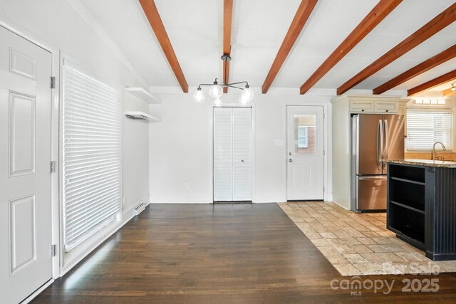 5229 Milford Rd, Charlotte, NC 28210 - kitchen with freestanding refrigerator, healthy amount of natural light, beamed ceiling, light stone counters, and open shelves