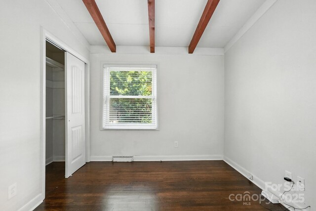 5229 Milford Rd, Charlotte, NC 28210 - unfurnished bedroom with beam ceiling, wood finished floors, and a closet