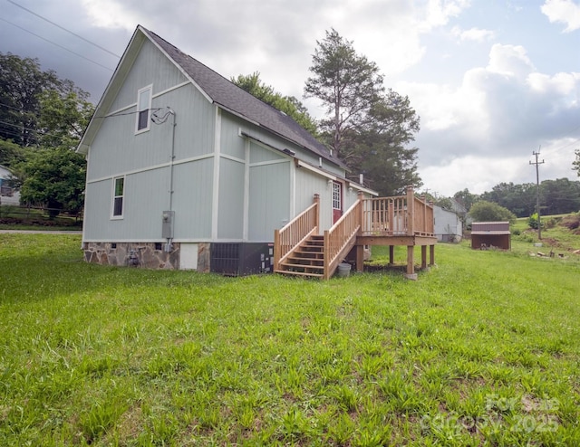 308 Hickory St, Granite Falls, NC 28630 - rear view of house featuring a lawn, a deck, a shingled roof, and stairs
