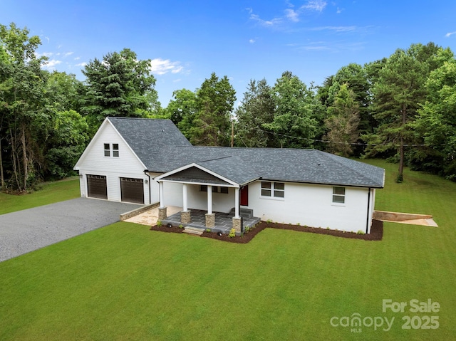 1115 Sides Rd, Salisbury, NC 28146 - view of front of home featuring a front yard, a garage, a shingled roof, and driveway