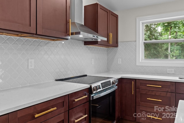 1115 Sides Rd, Salisbury, NC 28146 - kitchen featuring wall chimney range hood, electric range, and backsplash