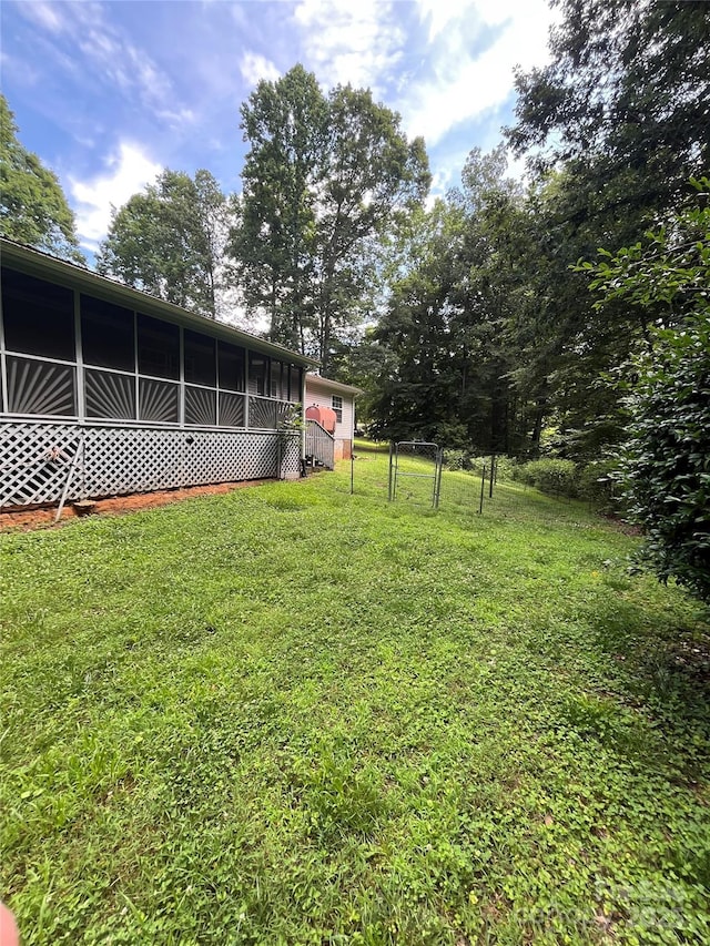 184 Winding Arbor Cir, Cleveland, NC 27013 - view of yard featuring a sunroom and a gate