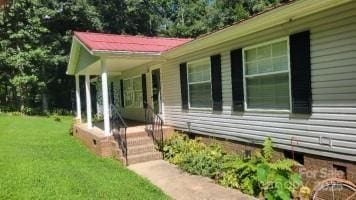 184 Winding Arbor Cir, Cleveland, NC 27013 - view of home's exterior with covered porch and a lawn