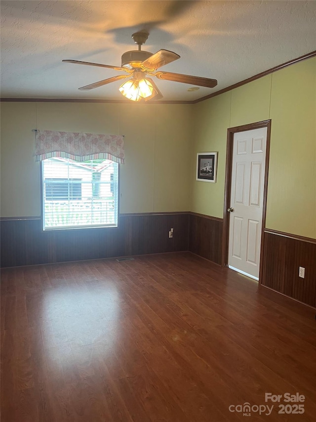 184 Winding Arbor Cir, Cleveland, NC 27013 - unfurnished room featuring wood finished floors, wainscoting, ornamental molding, a ceiling fan, and a textured ceiling