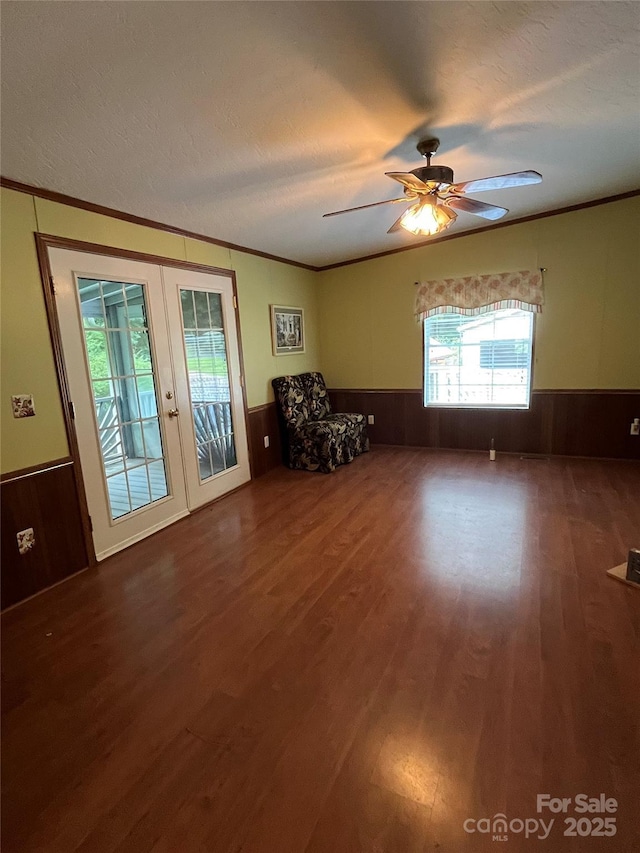 184 Winding Arbor Cir, Cleveland, NC 27013 - unfurnished living room with a wainscoted wall, wood finished floors, crown molding, french doors, and ceiling fan