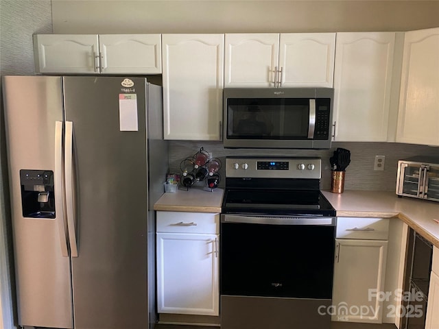 8421 Coulwood Oak Ln, Charlotte, NC 28214 - kitchen featuring appliances with stainless steel finishes, white cabinetry, light countertops, and tasteful backsplash