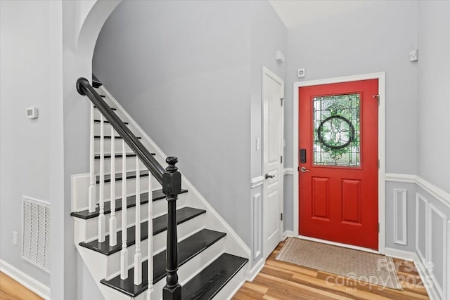 2527 Fossil Stone Ln, Fort Mill, SC 29708 - entrance foyer featuring light wood finished floors, stairs, and arched walkways