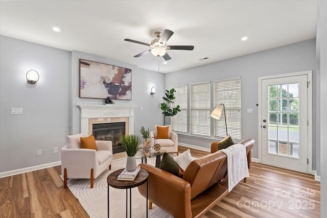 2527 Fossil Stone Ln, Fort Mill, SC 29708 - living area with a glass covered fireplace, ceiling fan, wood finished floors, and recessed lighting