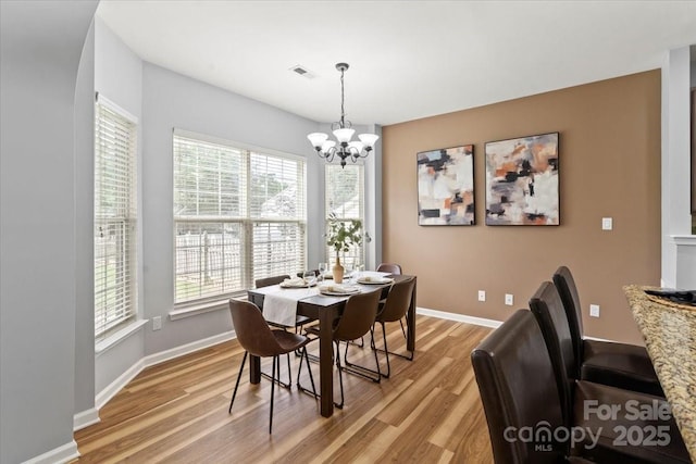 2527 Fossil Stone Ln, Fort Mill, SC 29708 - dining space featuring light wood-type flooring, plenty of natural light, and a chandelier