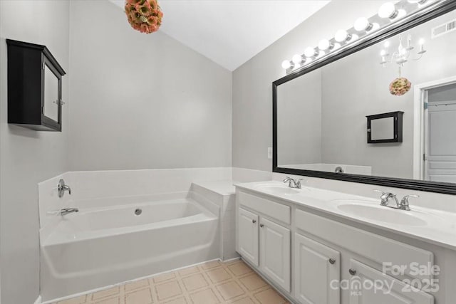 2527 Fossil Stone Ln, Fort Mill, SC 29708 - bathroom with vaulted ceiling, double vanity, a garden tub, and tile patterned floors