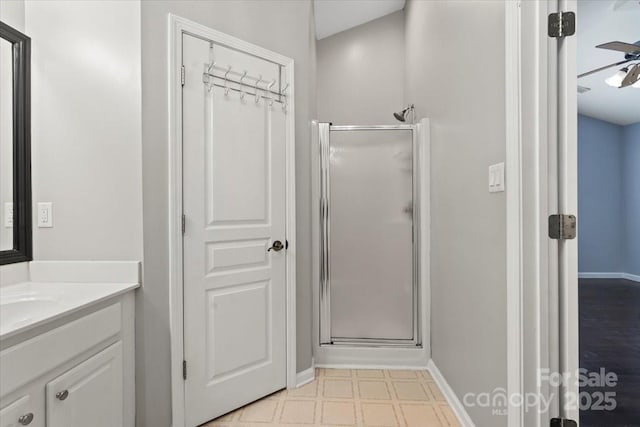 2527 Fossil Stone Ln, Fort Mill, SC 29708 - bathroom featuring a stall shower, vanity, tile patterned floors, and ceiling fan
