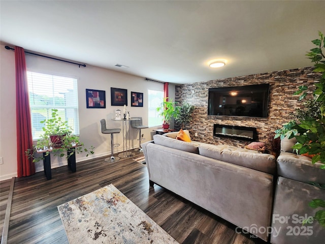 1047 Campbell Chase Ln SW, Concord, NC 28025 - living room featuring a stone fireplace, healthy amount of natural light, and dark wood-style floors