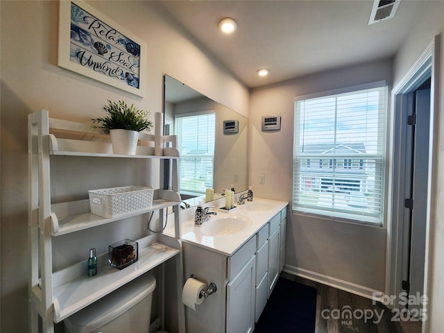 1047 Campbell Chase Ln SW, Concord, NC 28025 - bathroom with wood finished floors, double vanity, and recessed lighting