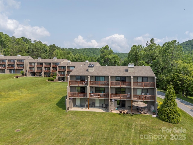 2881 White Oak Mountain Rd Unit D5, Columbus, NC 28722 - rear view of property with a yard, a chimney, a patio area, and a balcony